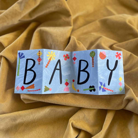 Beautifully designed Baby Concertina Greeting Card, fully opened to reveal its vibrant hand-painted artwork, displayed on a bright yellow background. Printed on eco-friendly recycled paper