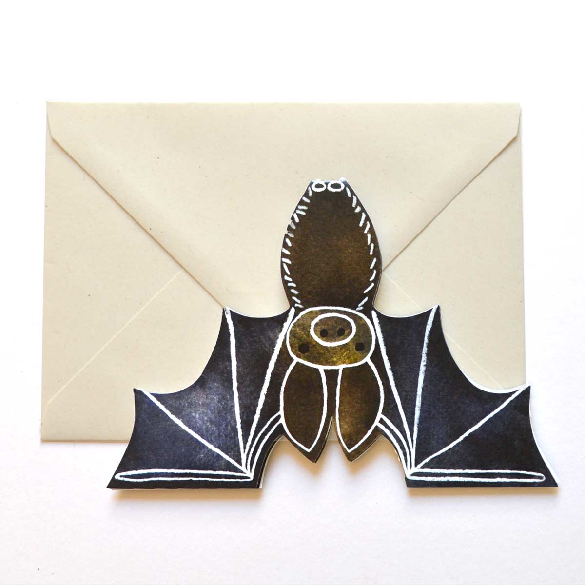 Bat shaped card flat lay open white background with vegan friendly 100% recycled mushroom coloured envelope