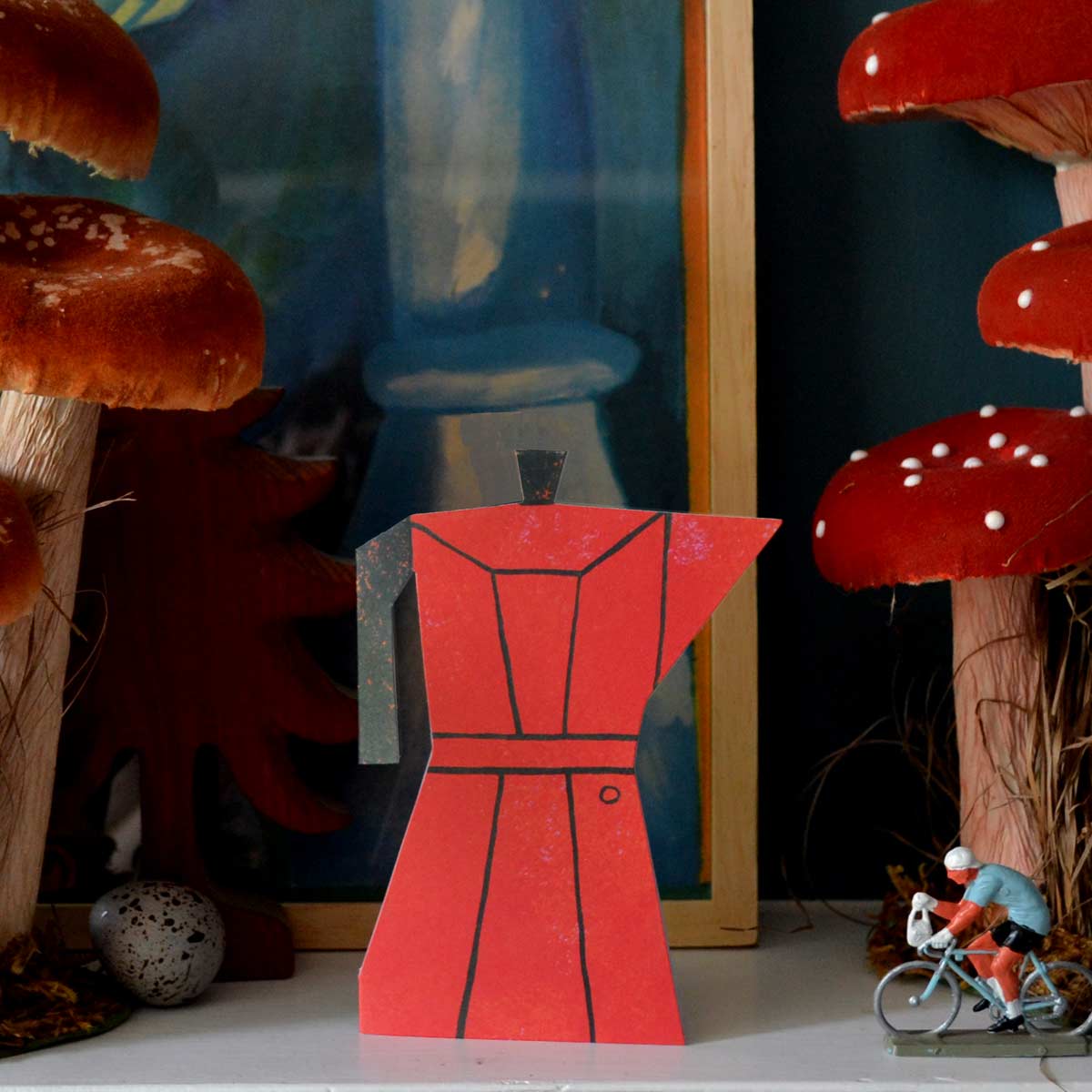 Red Coffee Pot shaped card as a keepsake on mantlepiece surrounded by ornaments