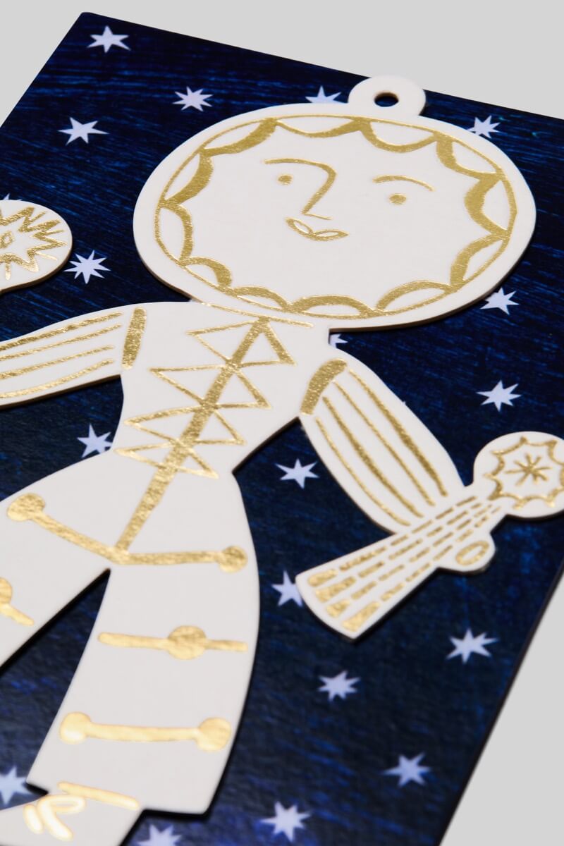 Decorative Sun Folk ornament with gold detailing on a blue background with stars