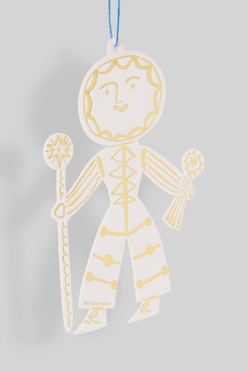 Decorative Sun Folk ornament with gold detailing on a gray background