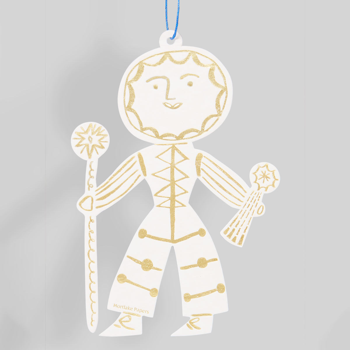 Decorative letterpress sun themed seasonal decoration on a gray background