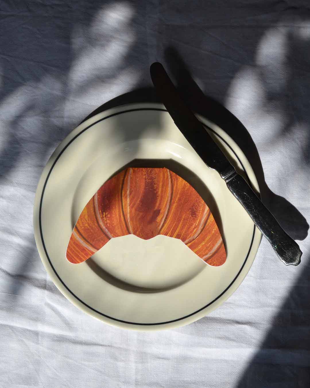 Illustrated croissant greeting card with a hand-drawn, golden-brown pastry on a white background.