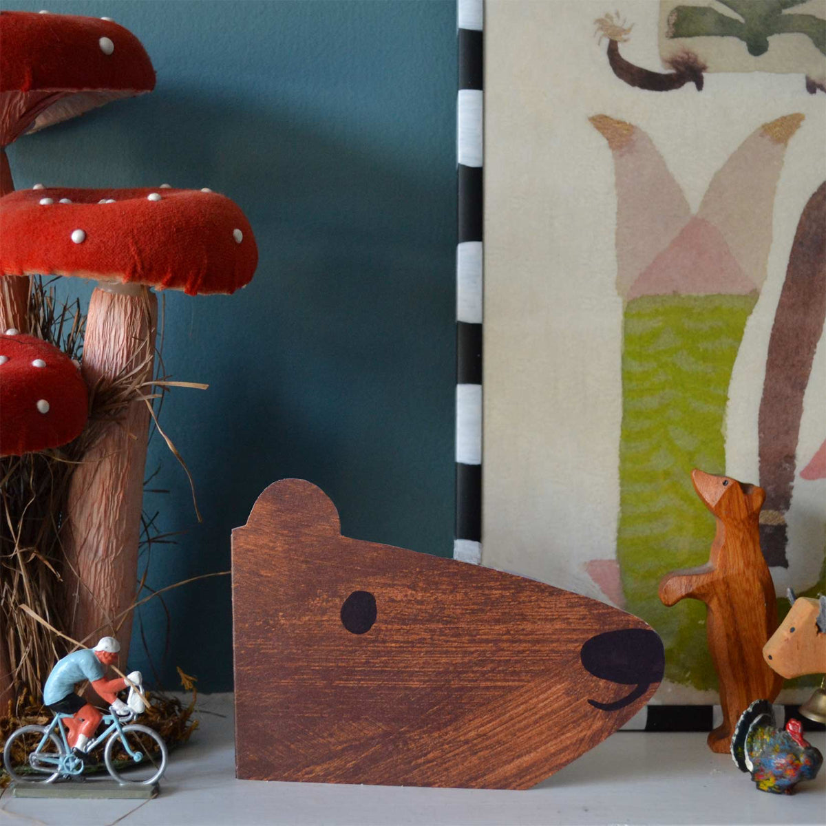 Eco-friendly brown bear shaped card on mantelpiece against blue background