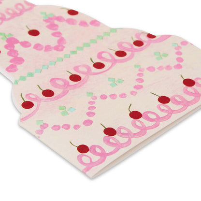 Wedding cake shaped greetings card with pink and green icing and red cherries on a white background