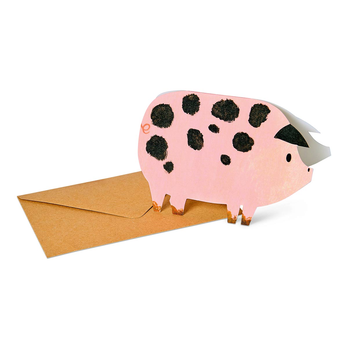 Pink spotty pig-shaped greetings card on a white background with brown recycled envelope
