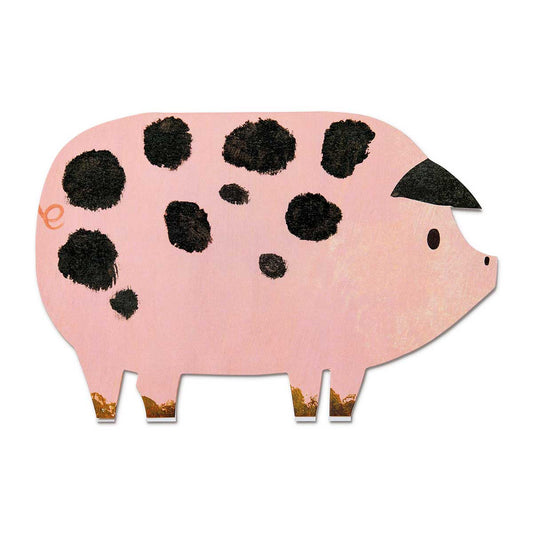Pink pig-shaped greetings card with black spots on a white background