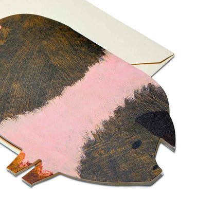 Close up detail of pig shaped card ontop of ivory coloured  envelope