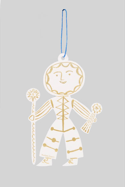 Decorative Sun Folk ornament in gold and white on a gray background